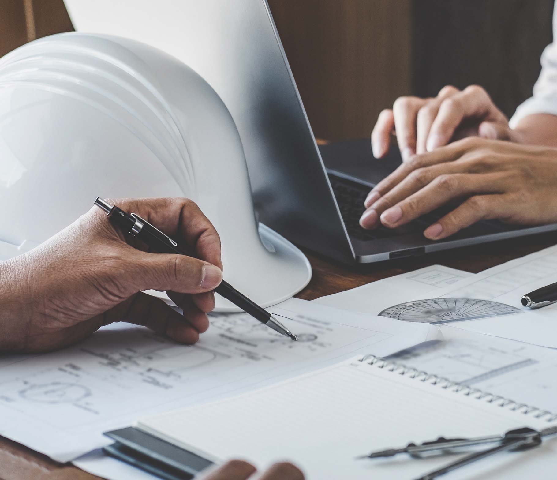 Engineers workiing on blueprints.
